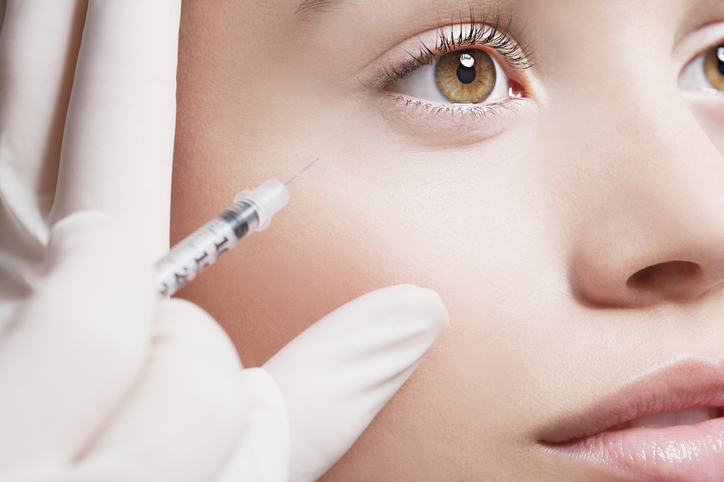Woman gazes straight ahead during a Botox injection at her favorite medspa