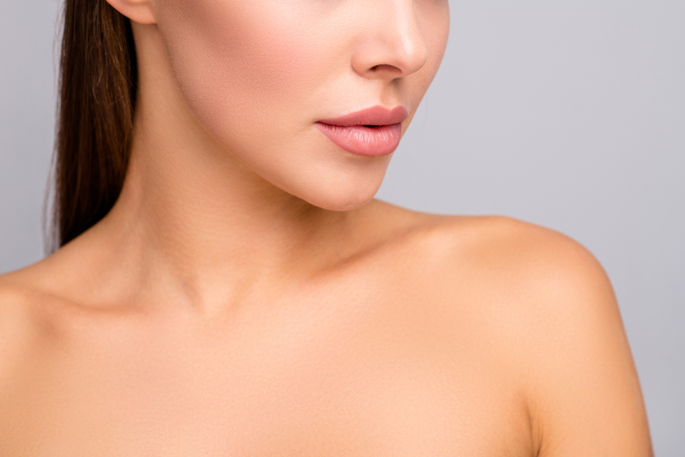 Woman with full, natural-looking lips after lip filler enhancement.