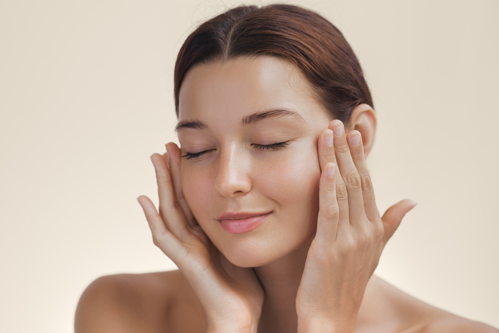 Woman with smooth, glowing skin highlighting the results of laser resurfacing and chemical peel treatments.